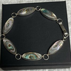 Sterling silver bracelet with iridescent abalone shell inlays.